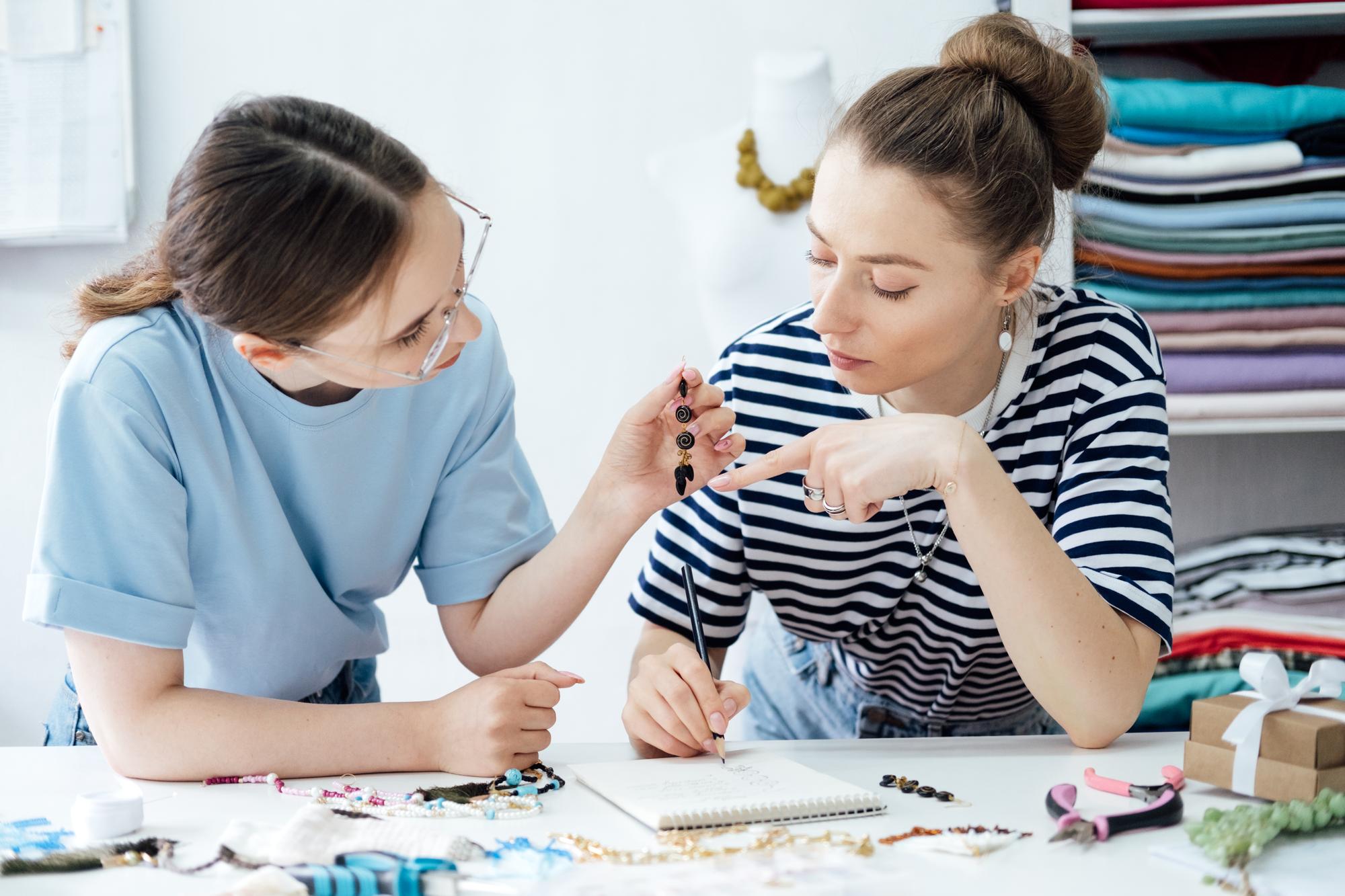 Instructor demonstrating embroidery stitch to student