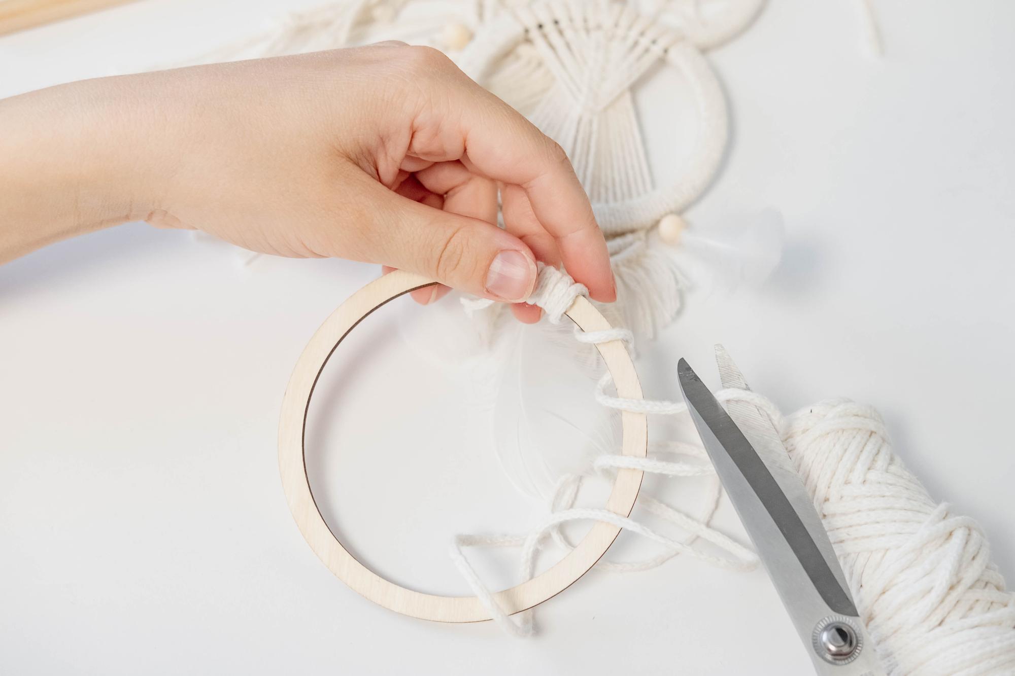 Artisan stitching on fabric with hoop and threads